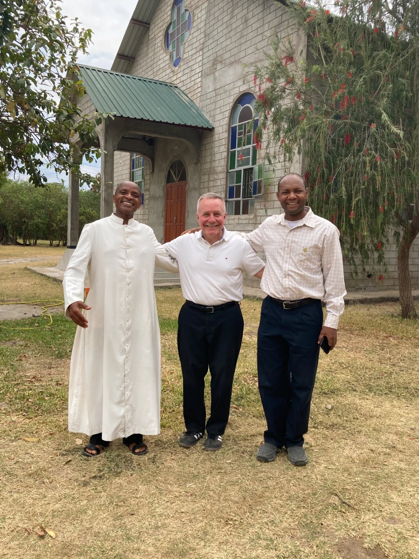 Deacon Rich with Fr. Andrew and parish leadership in front of St. Simon and Jude Church in Moshi, Tanzania